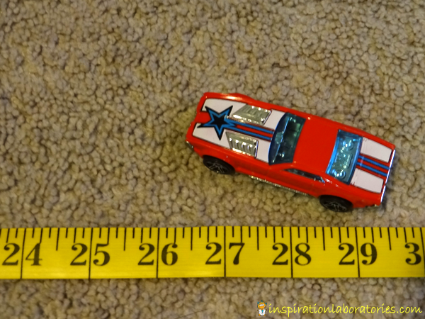Launching Cars Measuring Practice - an easy to set up, quick play idea that practices number recognition and measuring skills.