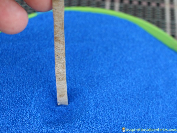 Use a piece of thin cardboard to measure the depth of the hole.