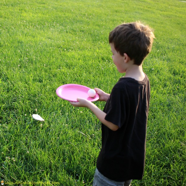 Create a golf ball carry game with paper plates.