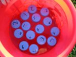 Head outside with this fun water sensory activity that practices number recognition and counting.