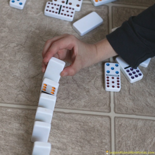 Design a domino experiment to determine which domino chain will go the fastest.