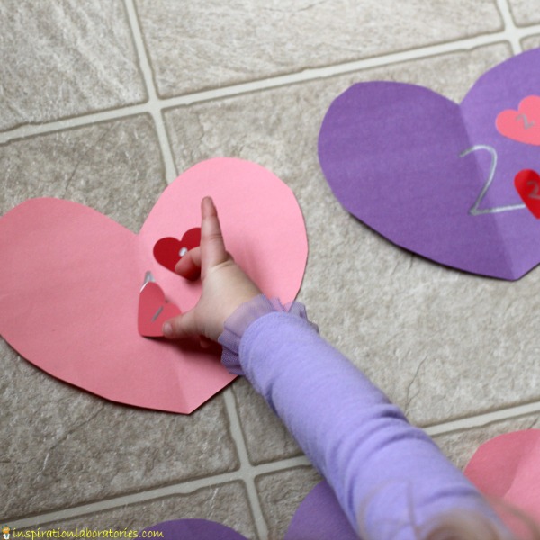 Practice number recognition and counting with a valentine hearts number line matching game.