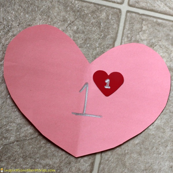 Practice number recognition and counting with a valentine hearts number line matching game.