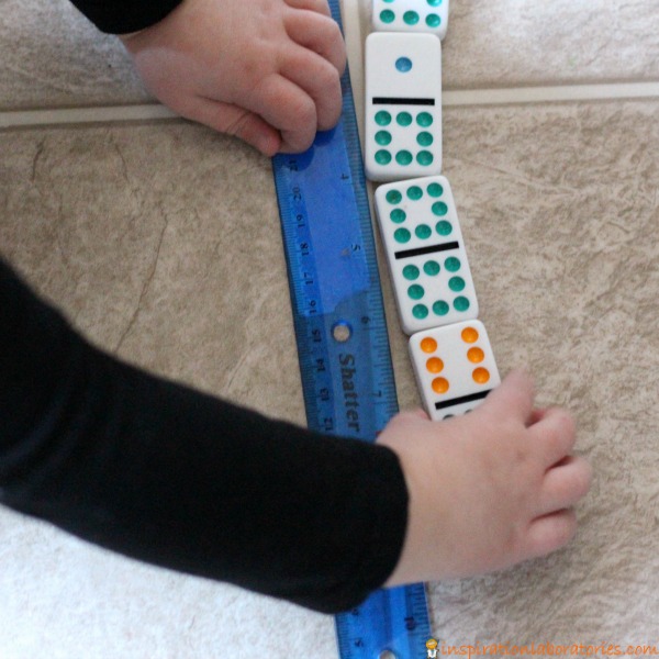 Practicing counting and measuring with dominoes.