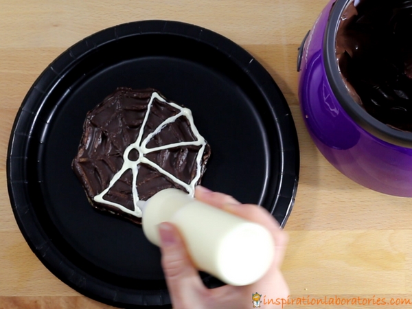 Make an easy spider web dessert with waffles and chocolate.