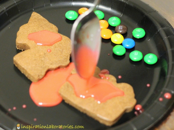 Decorate chocolate train cookies with colorful icing and candy.