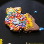 Decorate chocolate train cookies with colorful icing and candy.