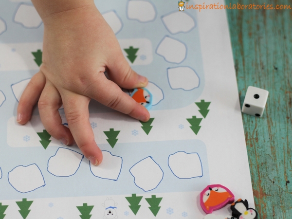 Play a preschool math game with a free printable winter math game board.
