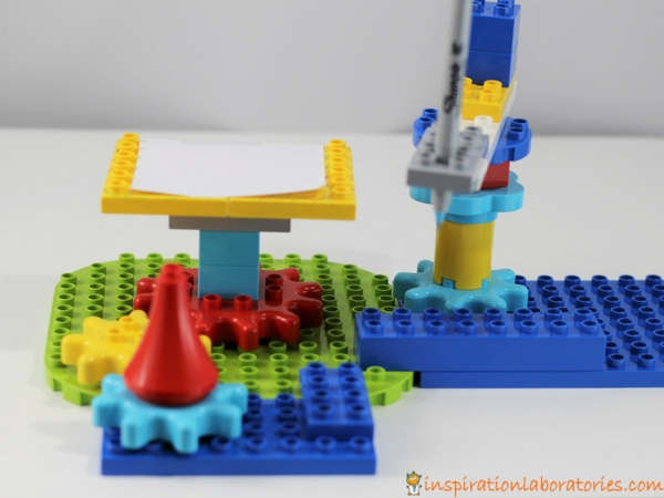 Design and build a LEGO drawing machine with DUPLO gears and bricks. Makes a great STEAM project for kids.