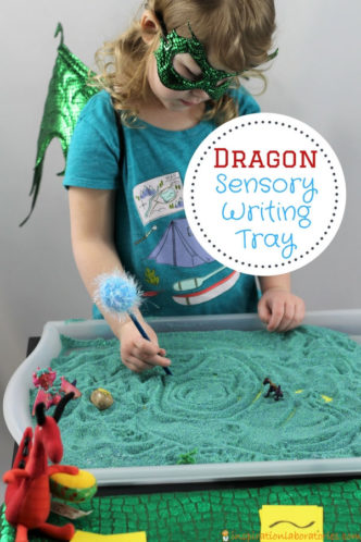 preschool girl drawing lines in a sand tray with text overlay Dragon Sensory Writing Tray