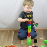 Set up an invitation to stack blocks for your toddler or preschooler. Work on STEM skills like balance, gravity, and cause and effect.