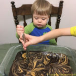 Making Chocolate Covered Peanut Butter Swirl Brownies is a fun activity for kids. Even toddlers can help.