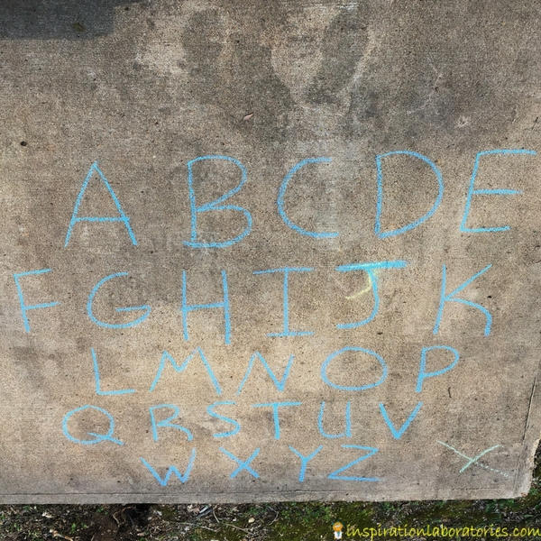 chalk alphabet drawn on sidewalk
