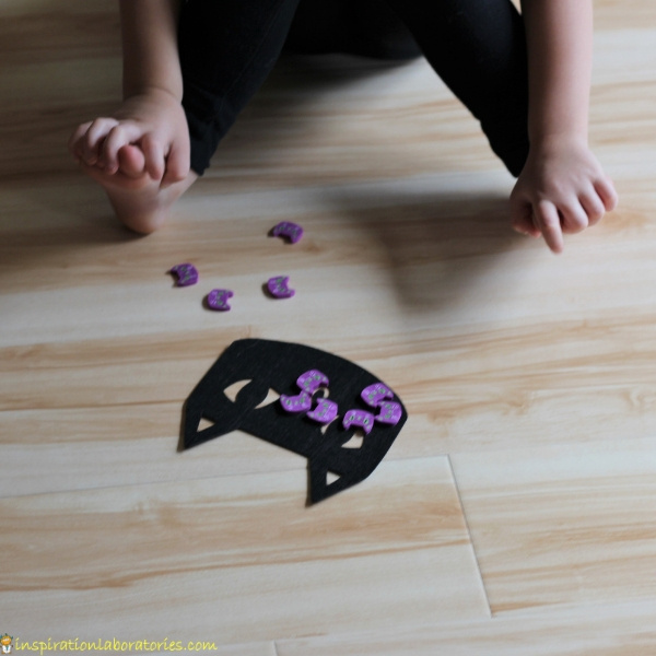 Halloween game - dropping cat erasers onto a felt cat