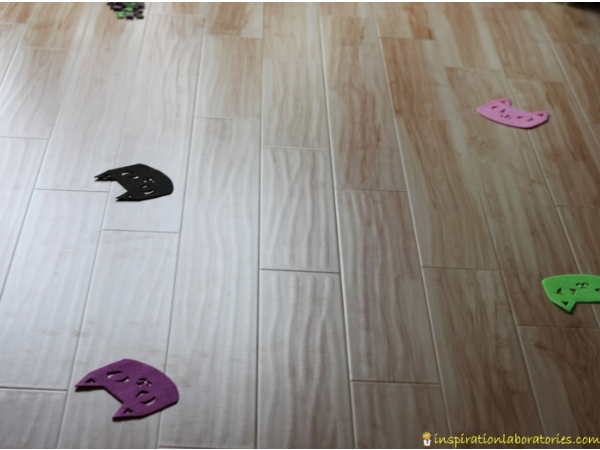 felt cat shapes spread out on the floor