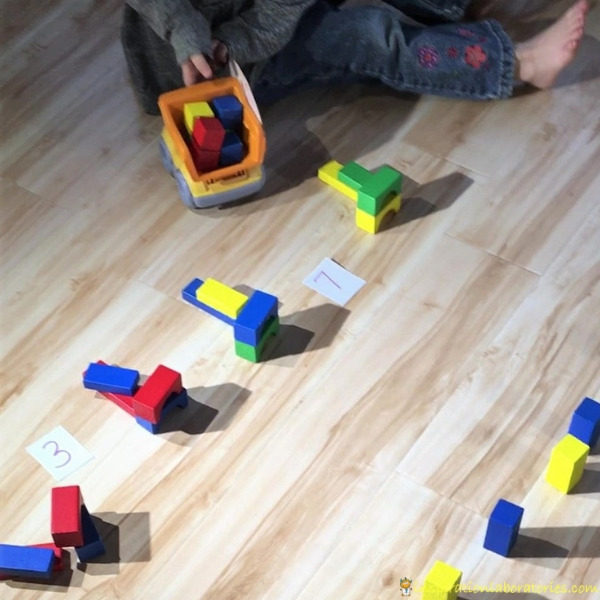 garbage truck counting game with toy trucks and blocks