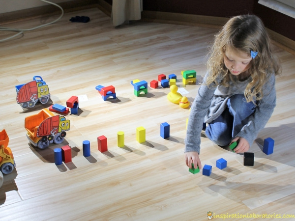garbage truck counting game with toy trucks and blocks