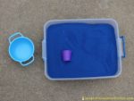 Dragon Treasure Sensory Bin – set up a simple sensory bin with colored sand, treasures, and dragons.