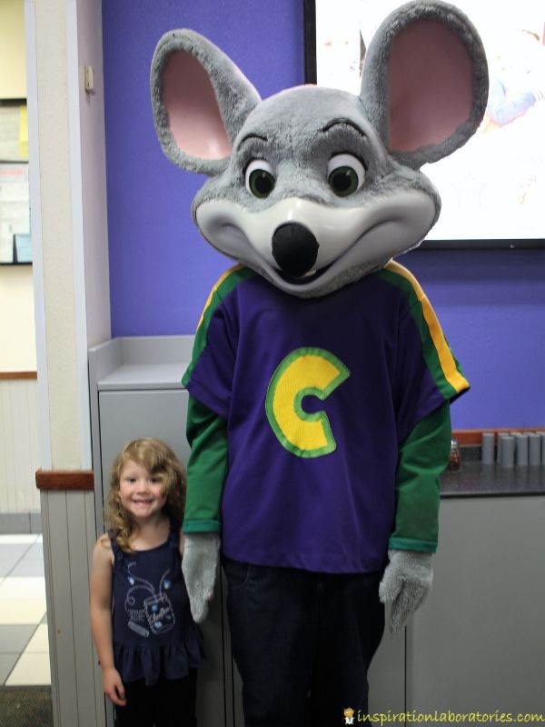 taking a photo with Chuck E. Cheese after his show
