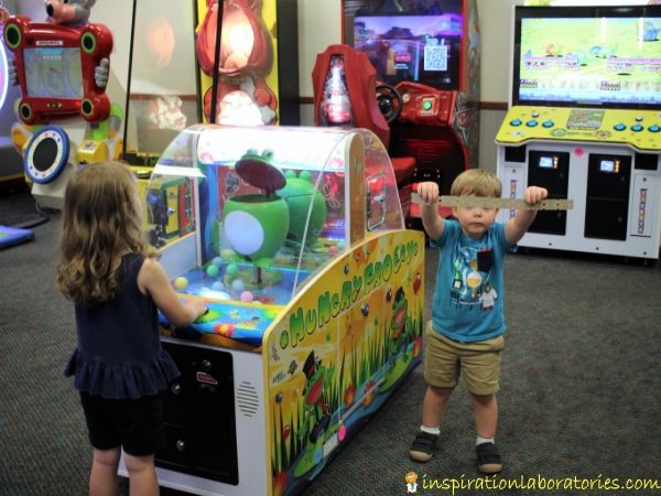 playing a Hungry Frog game at Chuck E. Cheese