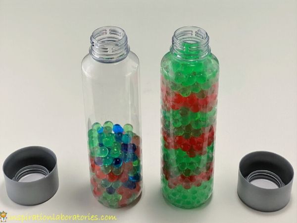 Voss plastic water bottles filled with red and green water beads