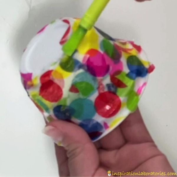 add glue and tissue paper to yogurt container