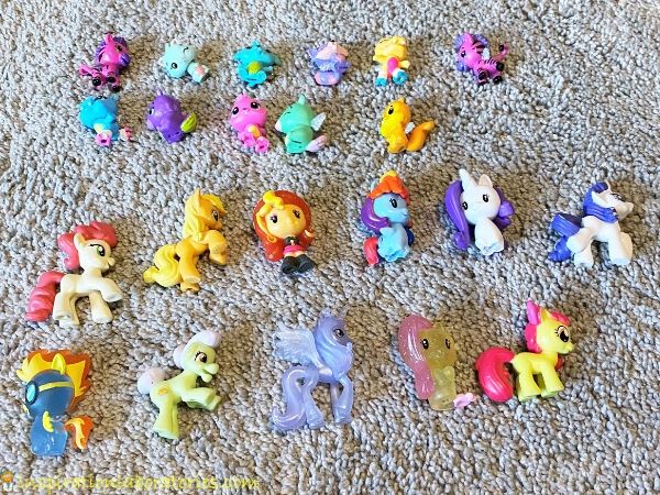 11 Hatchimals and 11 My Little Ponies lined up in 4 rows